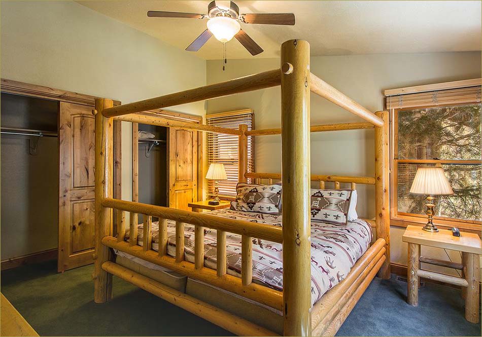 Large master bedroom upstairs features a king sized bed and mountain views.
