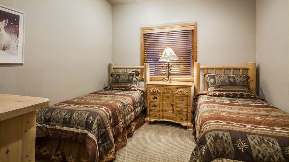 Fourth bedroom features twin beds and private bathroom.